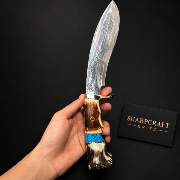 Copper Mai Damascus Kukri on a black background with Sharpcraft Knife card