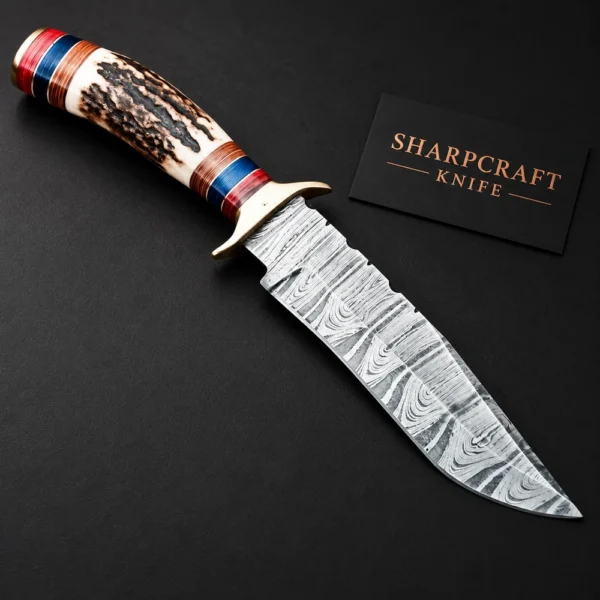Damascus Gut Hook Knife Stag Handle on a black background with Sharpcraft Knife card