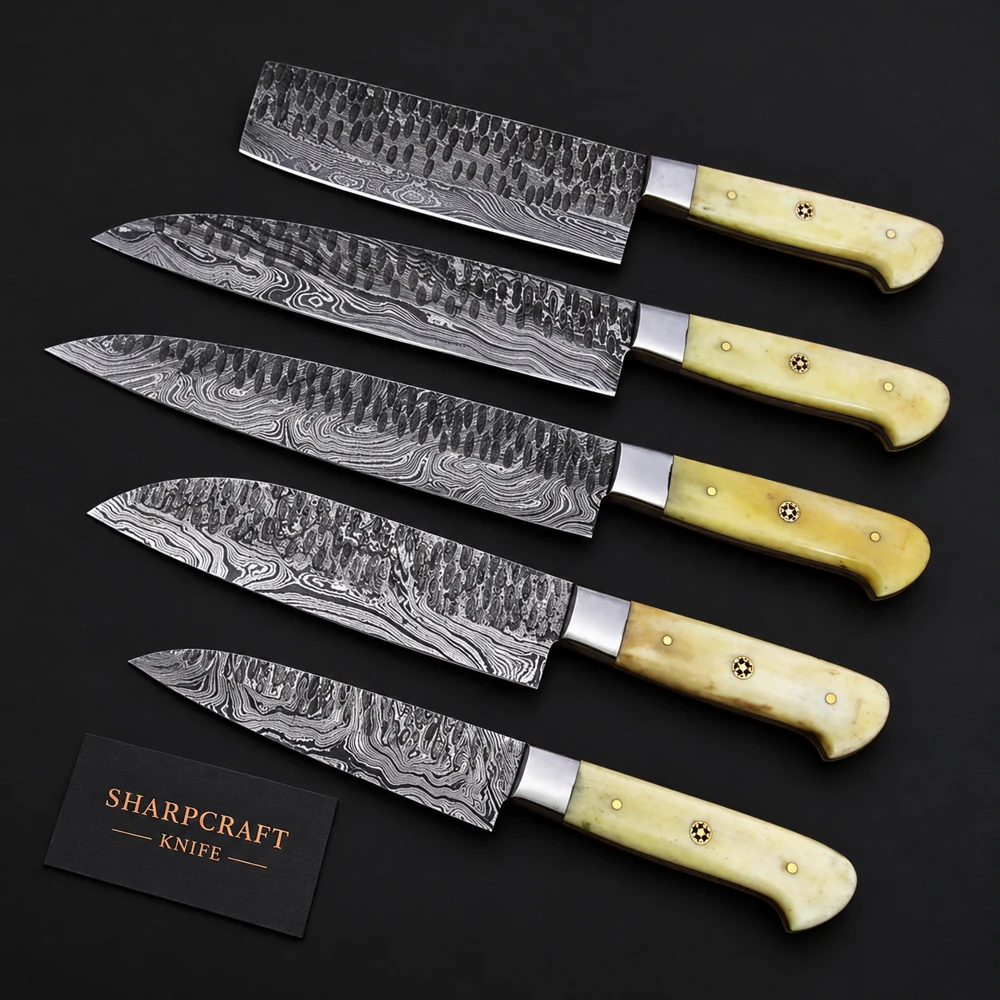 Five hammered Damascus kitchen knives with pale bone handles on a black background beside a Sharpcraft Knife card